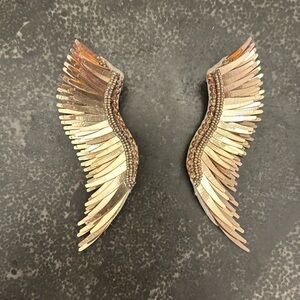 Gold colored feathered earrings. Large size. Excellent condition.